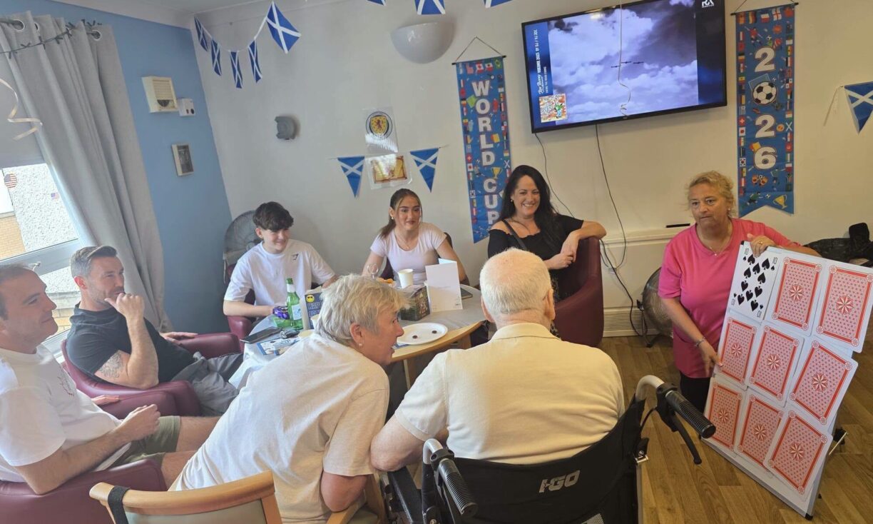 Residents playing games and watching football together on Father's Day at Carnbroe Care Centre