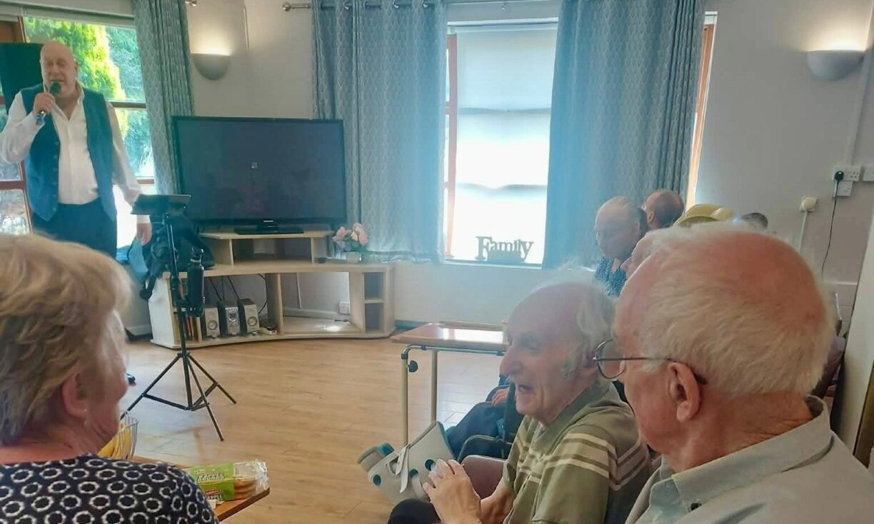 Resident taking part in a one-to-one activity session on Father's Day at River Brook care home